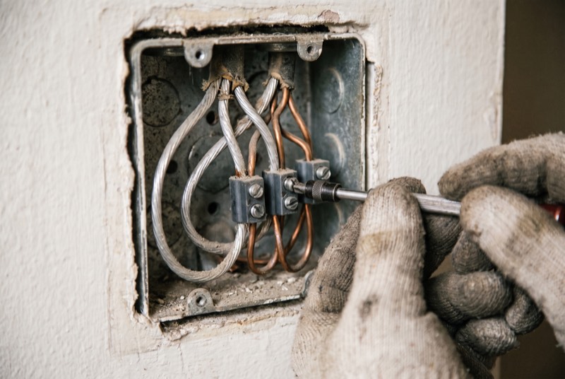 Aluminum wires joined to copper with set-screw lug connectors in a junction box