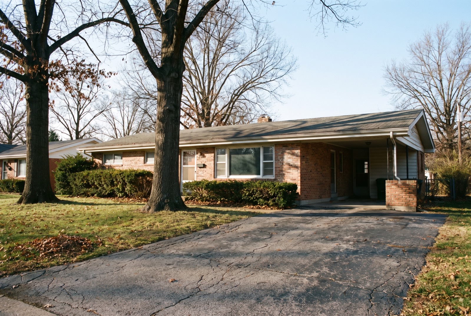 A late-1960s brick ranch house with a carport in a St. Louis suburb